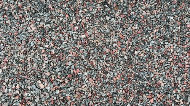 Texture of the surface covered with pink and gray gravel