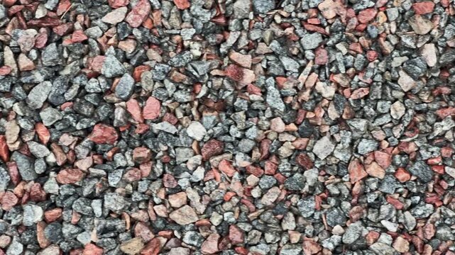 Texture of the surface covered with pink and gray gravel