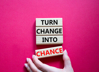 Change and Chance symbol. Concept words Turn Change Into Chance on wooden blocks. Beautiful bright red background. Businessman hand. Business and Turn Change Into Chance concept. Copy space.