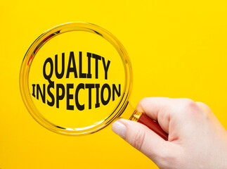Quality Inspection symbol. Magnifying Glass with words Quality Inspection. Businessman hand. Beautiful yellow background. Business and Quality Inspection concept. Copy space.