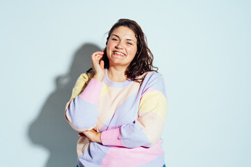 Plus size woman model posing in studio and having fun.