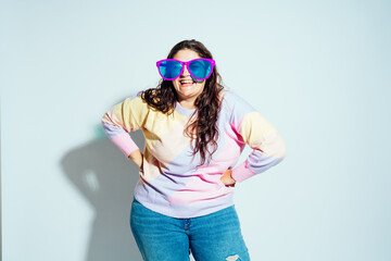 Plus size woman model posing in studio and having fun.