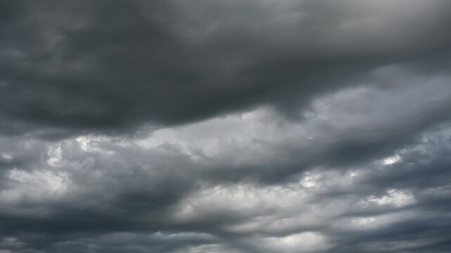 Time lapse of dark stormy clouds moving slowly through the frame. Only clouds in the clip
