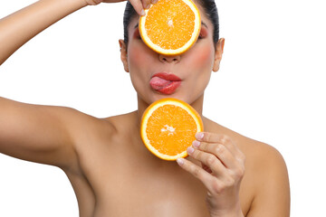 Woman playing with oranges for health and beauty