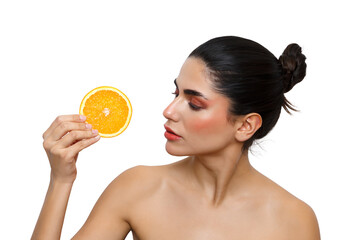 Woman holding orange slice for healthy skin care