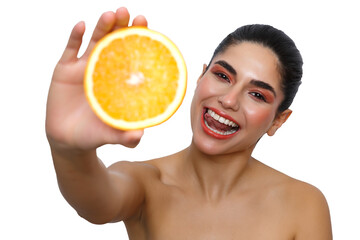 Woman holding fresh orange slice smiling tongue out