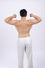 Fototapeta premium Back view of man showing double biceps