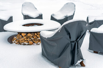 garden furniture and a fireplace after snowstorm