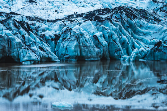 View of glacial ice formations reflected in still waters, creating a breathtaking scene of natural beauty and serene tranquility, South Island, Iceland.