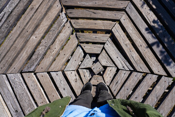 Unique Wooden Pattern Viewed from Above with Person Standing on Deck