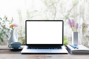 Laptop and blue coffee cup and flowers, notebook, cozy work from home