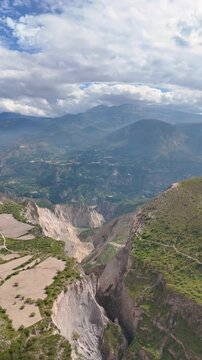 Vertical aerial drone footage flying over a large mountain ravine near the Pucar&aacute; de Rumicucho archaeological site close to Quito, Ecuador.