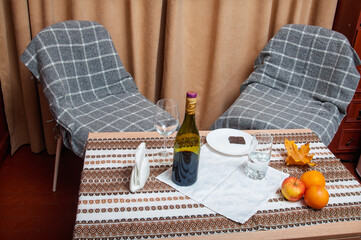 Cozy autumn evening with wine, chocolate, and fruit for two people