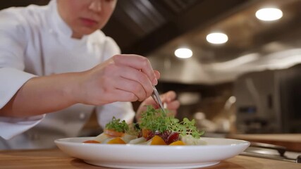 Chef artfully garnishing dishes with fresh greens in a restaurant kitchen