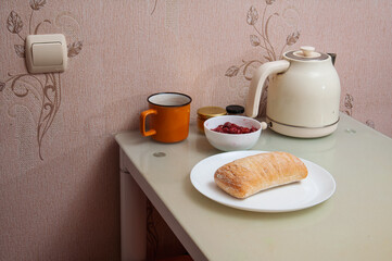 Simple breakfast setup with bread, berries, and a cup on a glass table