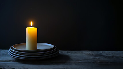 Yellow Candle Burning Empty Stacked Plates Dark Wood