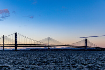 Suspension Bridge Over Water at Dusk