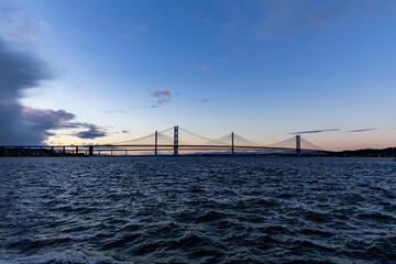 Suspension bridge over water at twilight