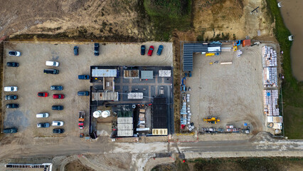 Construction site with vehicles, containers, and materials at Taylor Wimpey, Ripon.