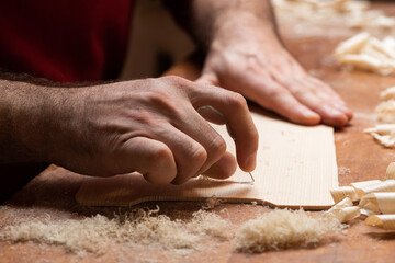 The master cycles the surface of the tagelharpa soundboard