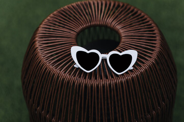Photo of white plastic heart-shaped sunglasses for lovers.