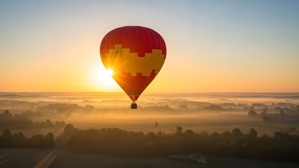 Obraz premium Vibrant hot air balloon soaring above foggy landscape at sunrise