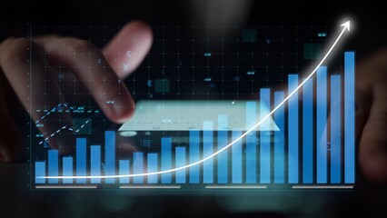 Hands interact with a smartphone, displaying a financial bar chart and graph overlay, symbolizing growth and data analysis in a modern business setting. Copula