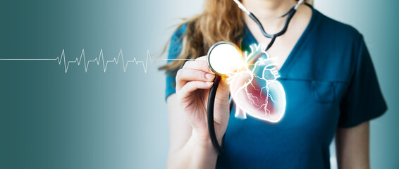 young female doctor holding stethoscope  to examine patient heart functions and blood vessel on virtual interface. Medical technology and healthcare treatment to diagnose heart disorder. Copy space.