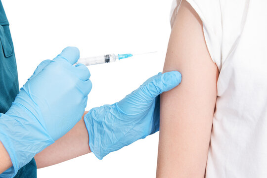 Isolated close up of nurce or doctor hands in blue gloves give injection to little sick child patient, scheduled for vaccination in clinic, healthcare concept.