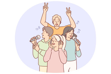 Woman wearing headphones listens to popular music, standing near singing people with microphone