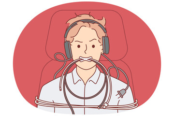 Man is tied up with computer wires and shows aggressive grimace caused by professional burnout