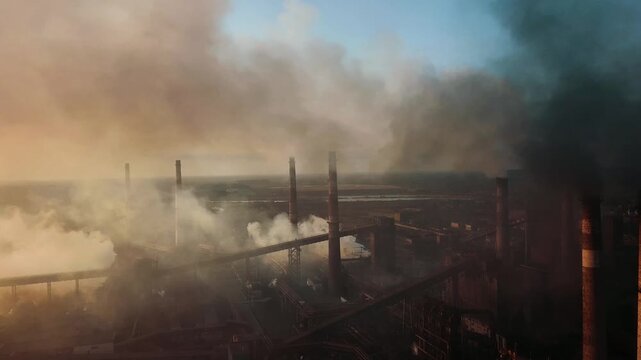 A drone flyover of a steel plant demonstrates the environmental impact and smoke from the chimneys.