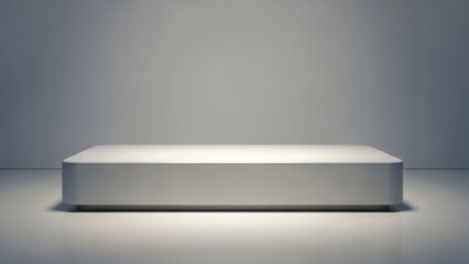 a large white rectangular object on a gray floor with a light shining on it from above slowly fading out