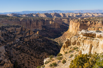 Expansive aerial view of the Wedge Overlook in the San Rafael Swell, Utah. The "Little Grand Canyon" of the San Rafael River winds through deep sandstone gorges under a vast desert sky.
