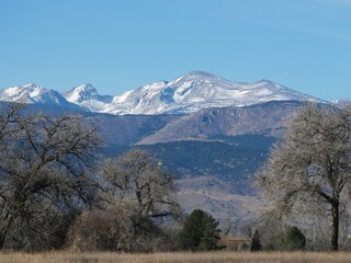 Snow-Dusted Mountain Peak in Early Spring Under Clear Blue Sky