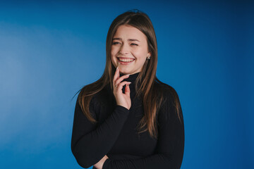 Studio picture of cheerful woman showcasing professional attire and warmth