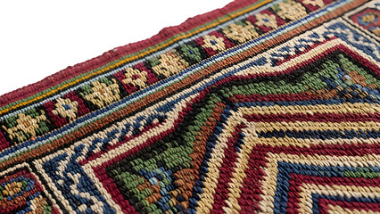 Closeup detail of a richly colored, intricately woven antique oriental rug with geometric patterns and visible texture isolated on transparent background