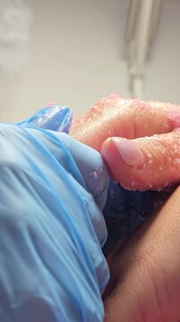 Close-up video of a hand peeling scrub massage in a nail salon. Skincare and beauty treatment.