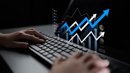 Hands typing on a keyboard in a professional setting, with digital graphs and arrows illustrating data growth and analysis for business and finance insights. Scalp
