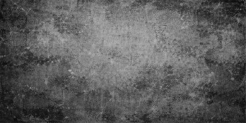 Obraz premium A dark aged vintage wallpaper featuring a rough black and white grunge texture with a dirty old paper pattern on a weathered gray stone concrete wall surface backdrop