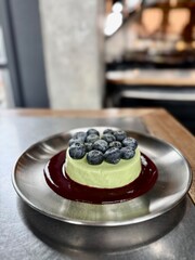Green Matcha Cheesecake with Fresh Blueberries and Berry Sauce