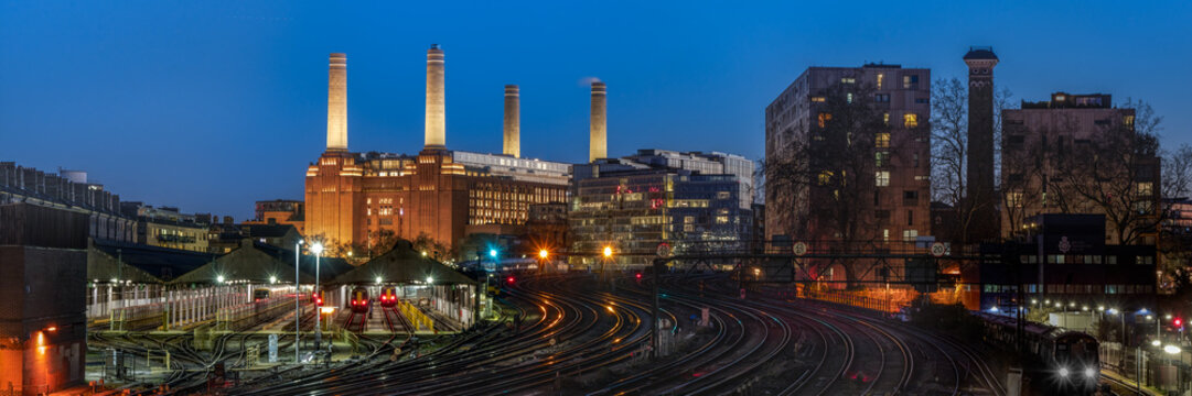 Panorama view of Battersea Power Station from Ebury Bridge Road across railway lines in blue hour