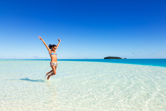 Woman jumping in the sea, Aitutaki, Cook Islands