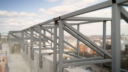Unfinished metal framework on city building rooftop
