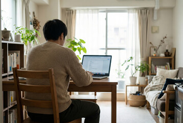 Man Working on Laptop at Home Interior