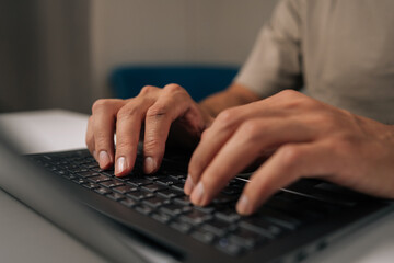 Close-up hands of unrecognizable programmer male typing code on laptop keyboard, showcasing process of software development and coding expertise. Concept of remote working on distance workplace.