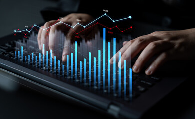 A close-up view of hands typing on a laptop, complemented by an overlay of financial graphs and market data, showcasing modern analytics in the workplace. Scalp