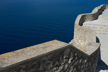 Stone wall overlooking calm blue sea.. Palma de Mallorca, Spain