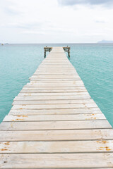 Fototapeta premium Wooden pier extending into turquoise water.. Palma de Mallorca, Spain