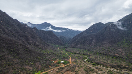 Panoramic aerial drone view of the mountains of Mayasc&oacute;n covered by clouds, Lambayeque, Peru